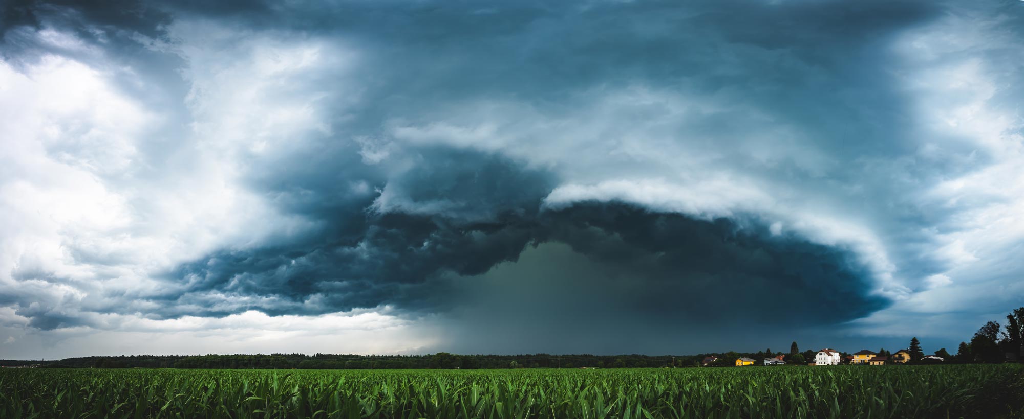 dark thunderstorm over corn field